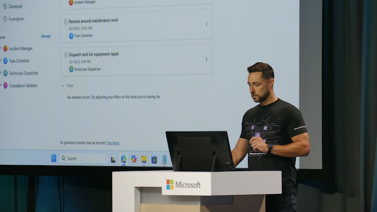 Matt at a Microsoft lectern, demoing a team of AI agents on the big screen